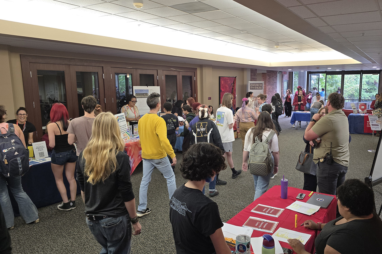 A group of students inside a Willamette building during a club fair