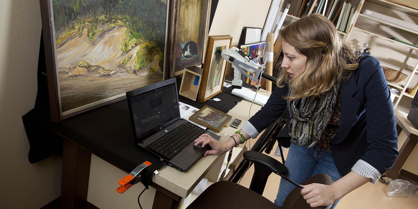 A Willamette University student studies a piece of art
