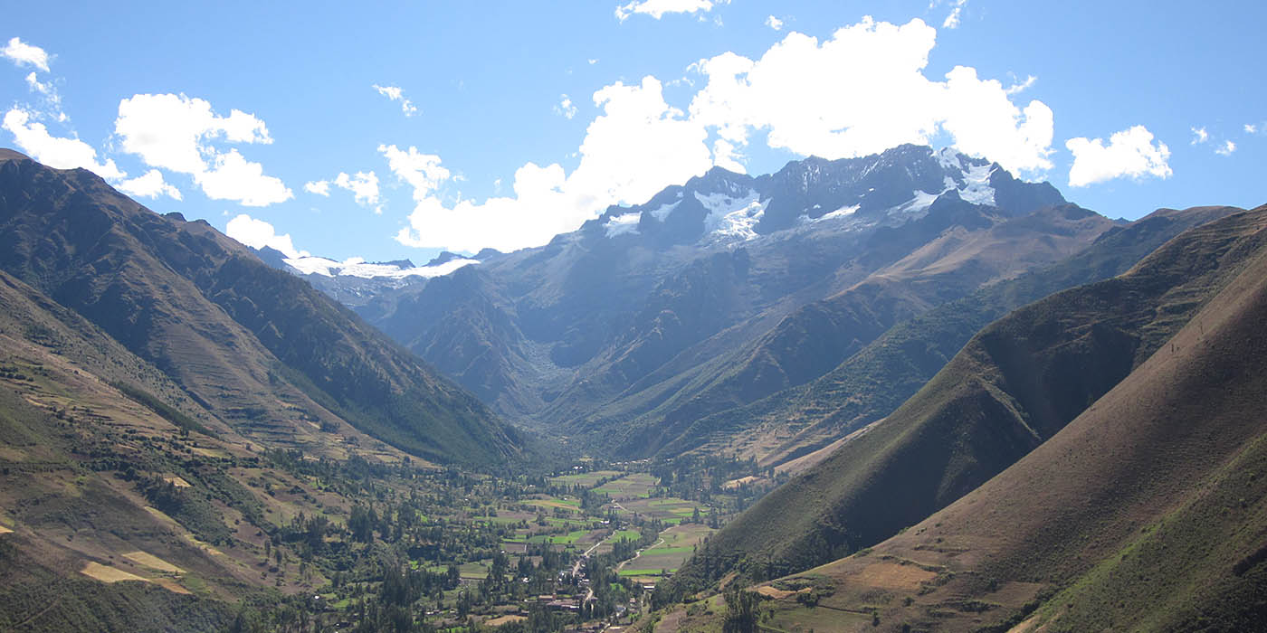 Scenic view of mountains and a valley community, illustrating the diverse landscapes and cultural significance explored in a Latin American Studies academic program, with a focus on the region&rsquo;s history, geography, and societal development.