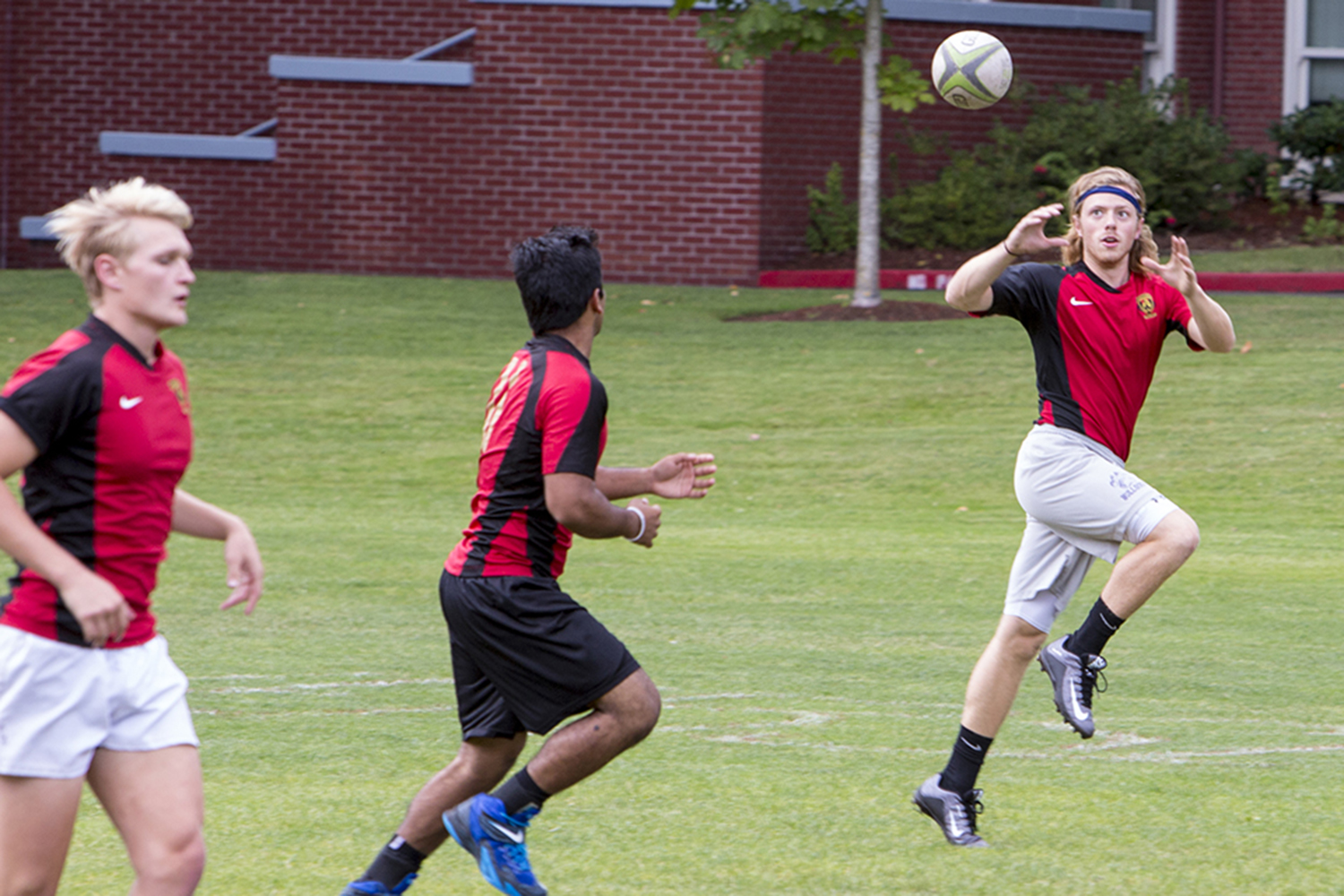 Three athletes playing a game wearing matching shirts