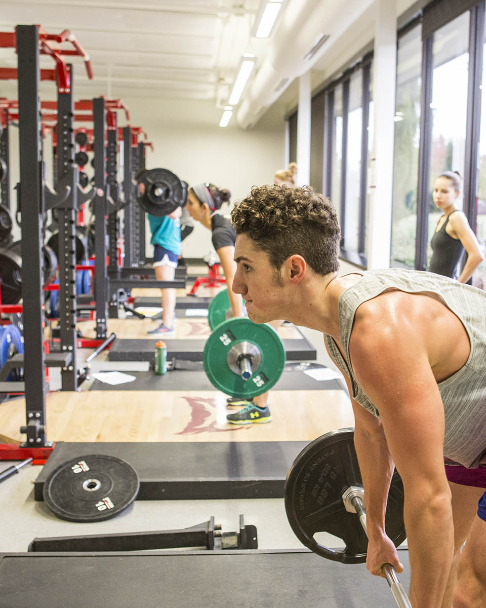 One athlete lifting weights at the Sparks Athletic and Recreation Complex