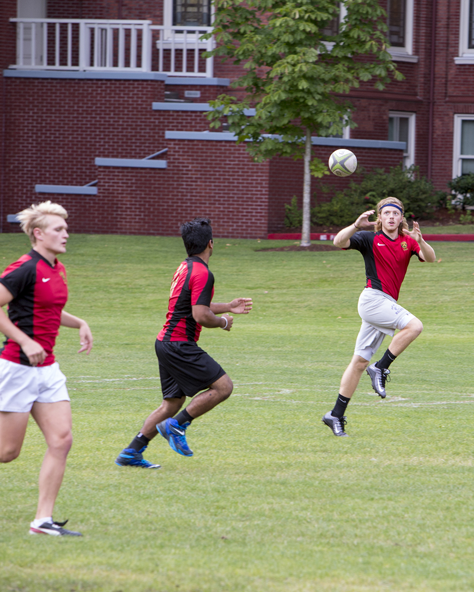 Three athletes playing a game wearing matching shirts