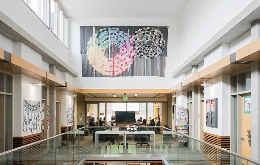 An interior building at Willamette featuring modern designs and glass railings along with art