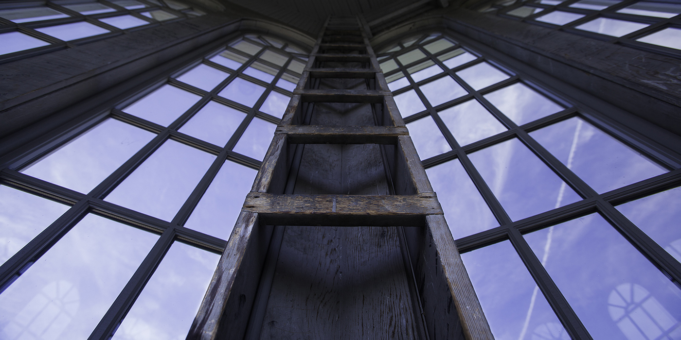 A view from inside a cupola showing the windows and a ladder built into the wall.