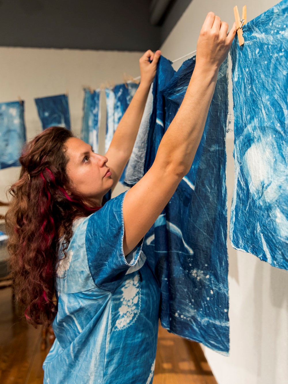 Photo of Carmina Eliason hanging up art
