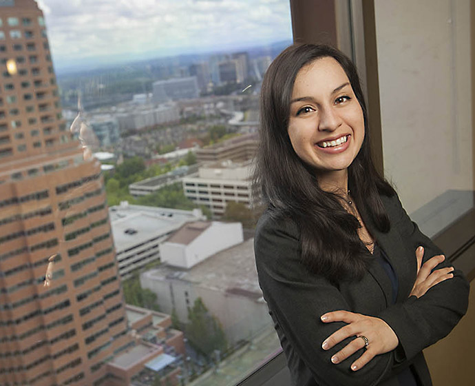 headshot of smiling female student against a city backdrop