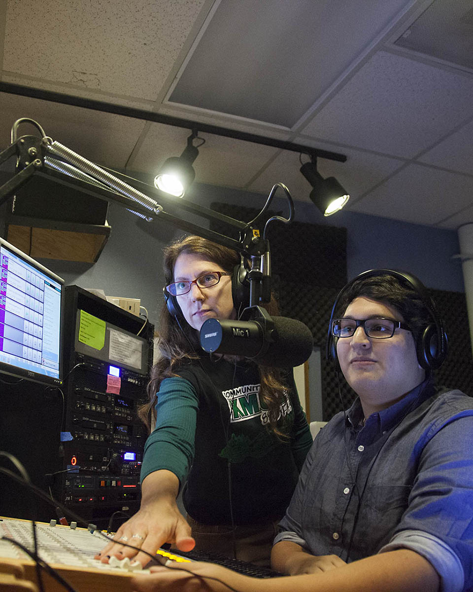 Two people in a studio working on a project