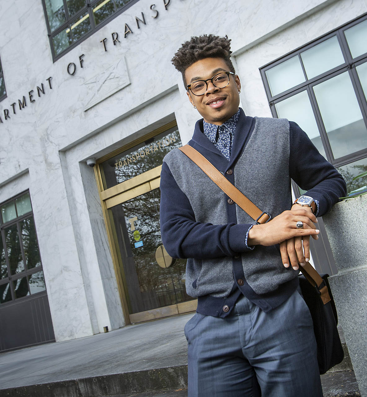 A student standing outside of the Department of Transportation
