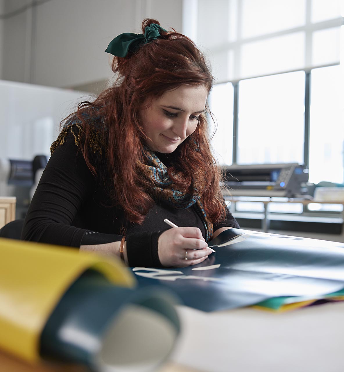 Willamette female art student cutting out shapes