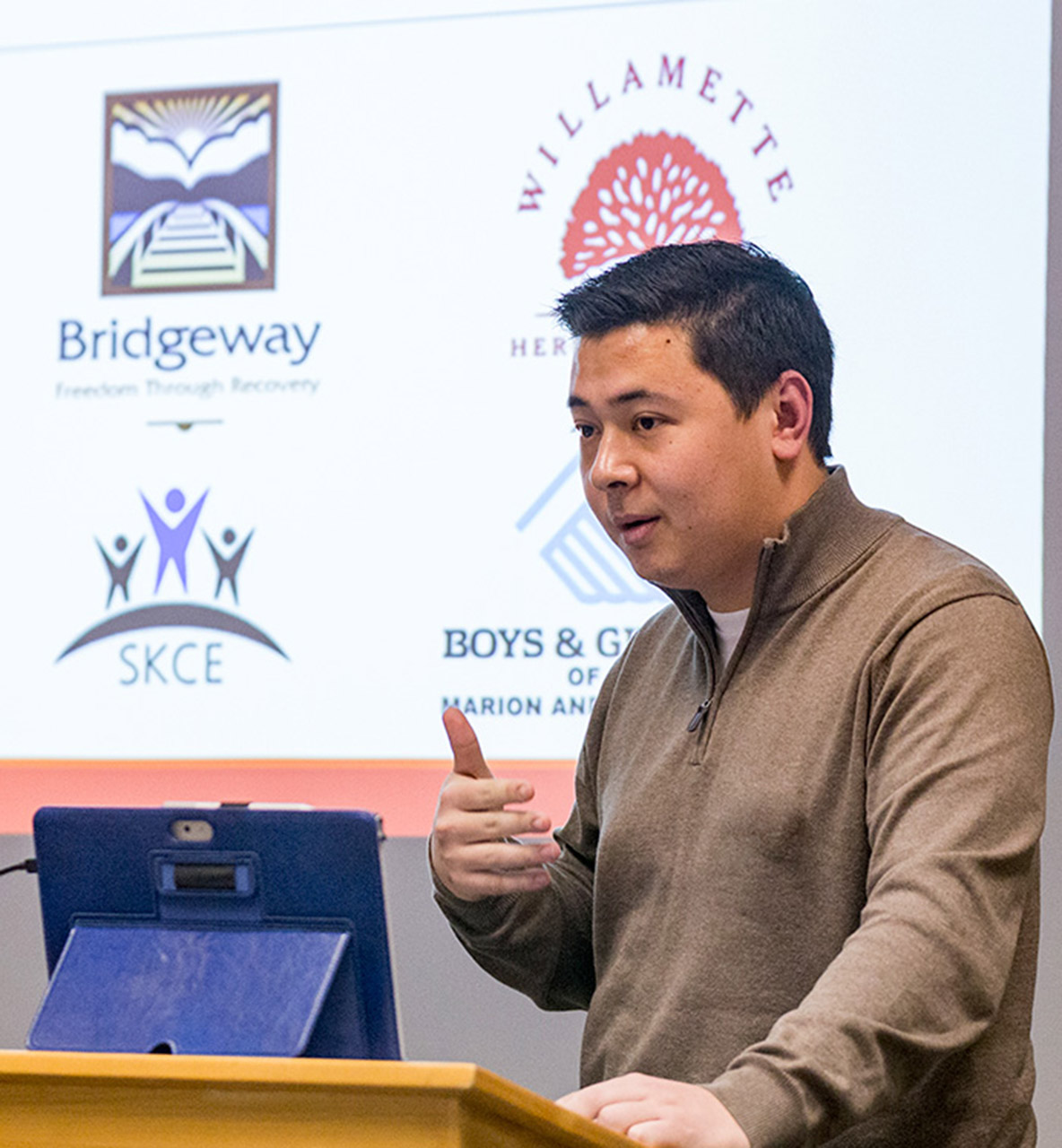 Man presenting at a podium 