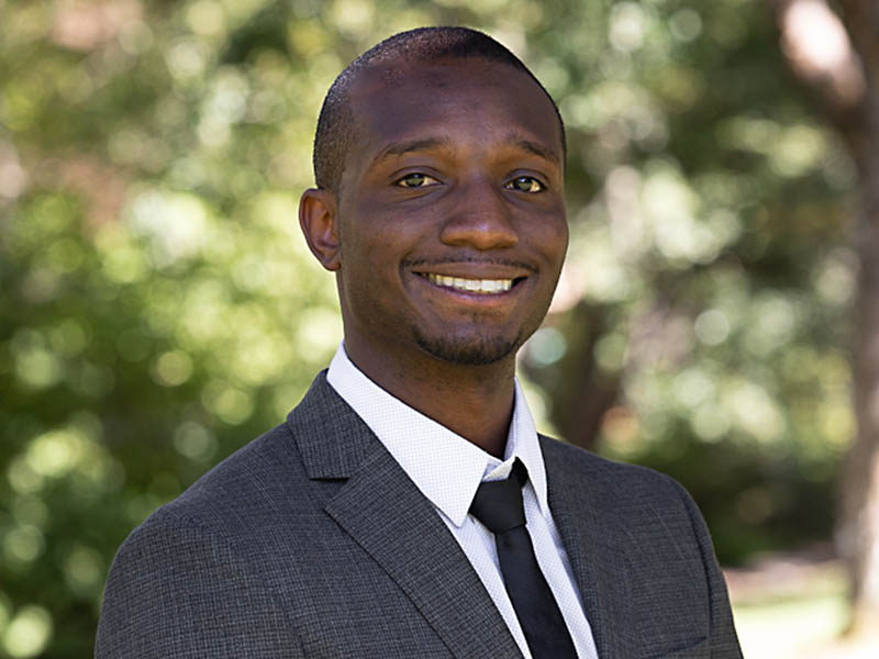 Headshot of Raymond White smiling at the camera 