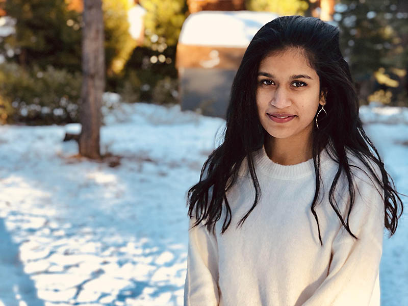 saniya lakka looking towards the camera with a snowy backdrop
