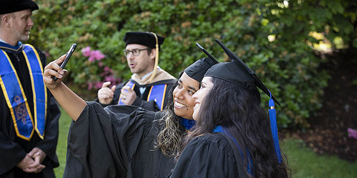Students taking a selfie at graduation