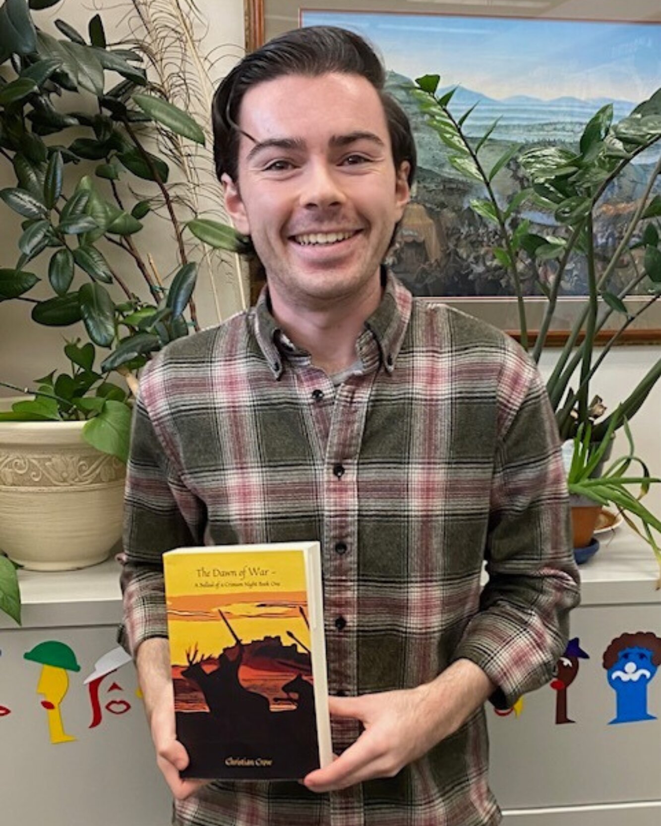 Headshot of Christian Crow holding his book "The Coldest War"