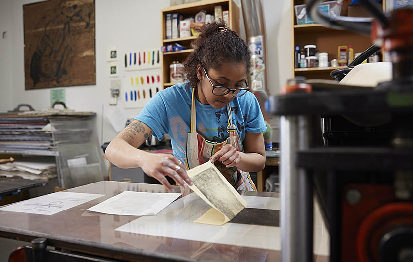 A student practicing printmaking techniques