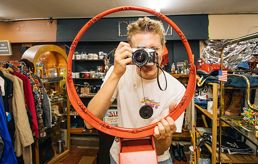 A person taking a photograph inside of a metal orange circle