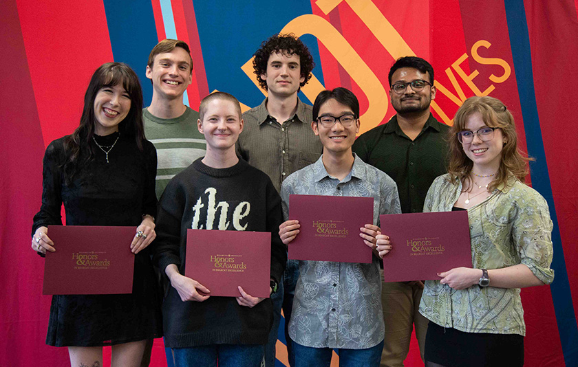 People posing with awards