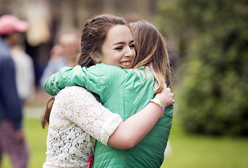 Two students hugging each other