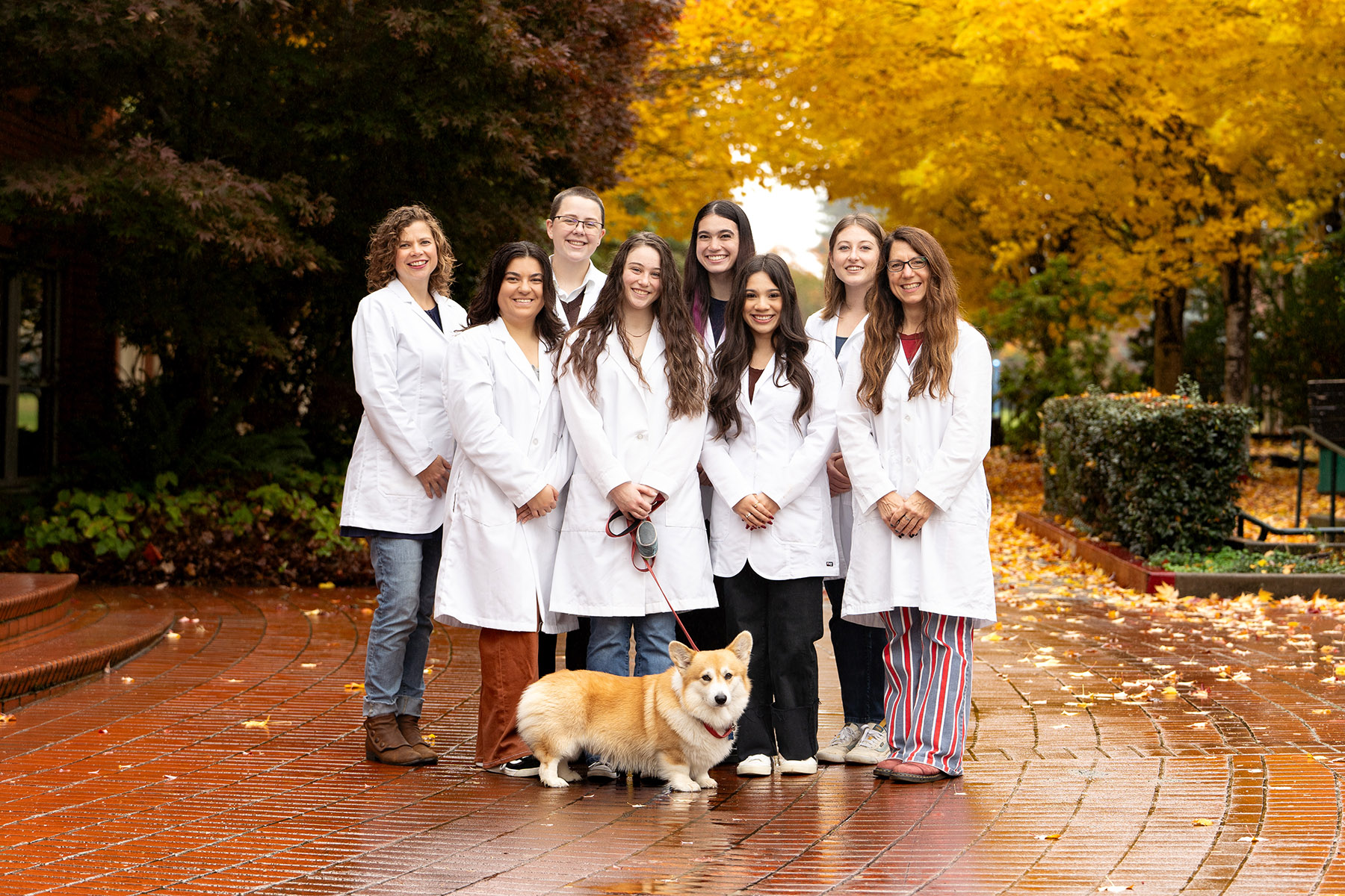 Group photo of the Willamette Webber Scholars and a corgi